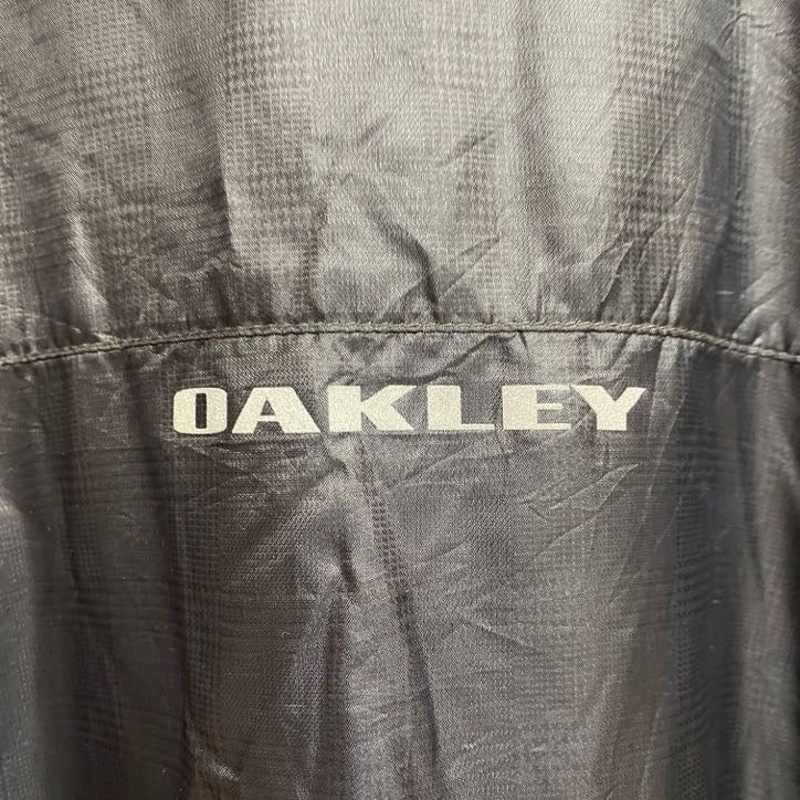 古着 used　OAKLEY　オークリー　長袖薄手ナイロンジャケット　ワンポイント刺繍　地球　pfm　ダークグレー　Lサイズ